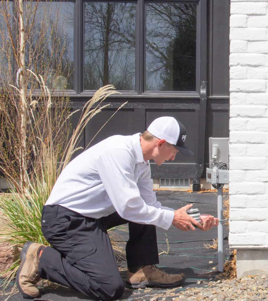 Pointe Pest Control Technician dusting cracks and crevices at a customer's house